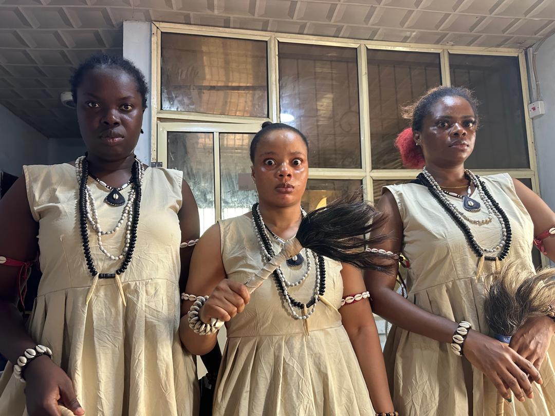 Cast in cream cowrie-shell costumes for Broken Womb