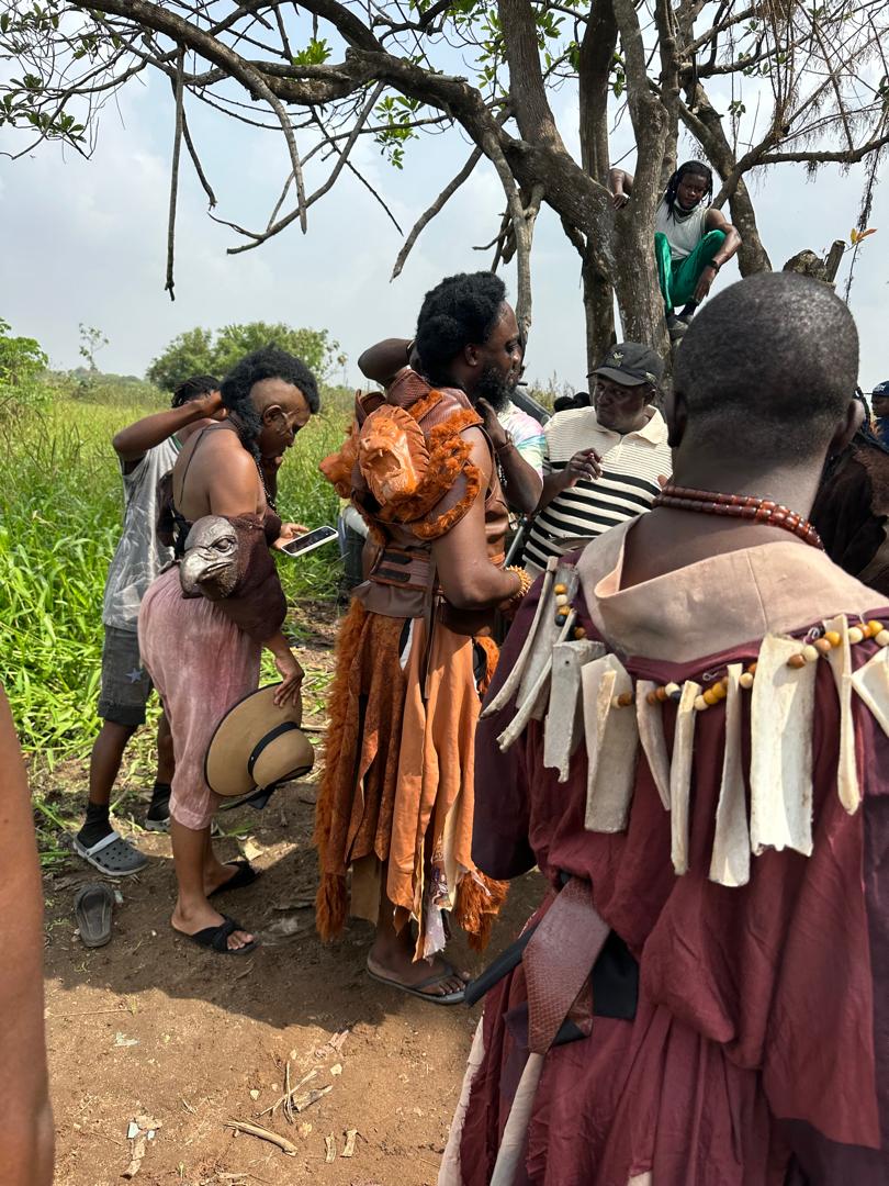 Warriors in animal-skull masks and fur costumes on set